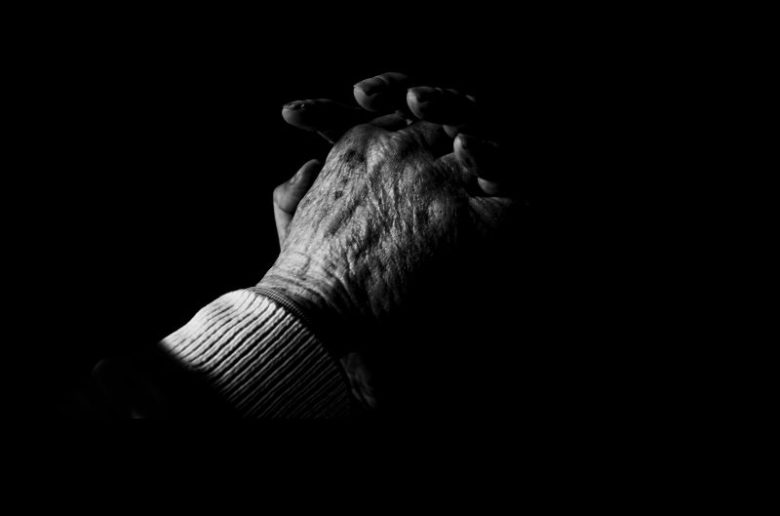 A person 's hands are shown in the dark.