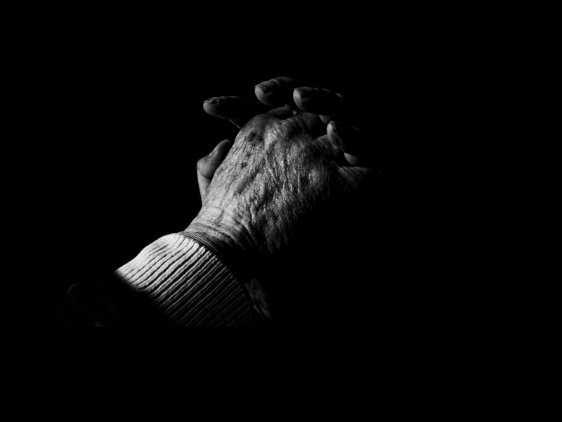A person 's hands are shown in the dark.