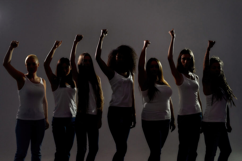 A group of women standing in front of each other. women's rights