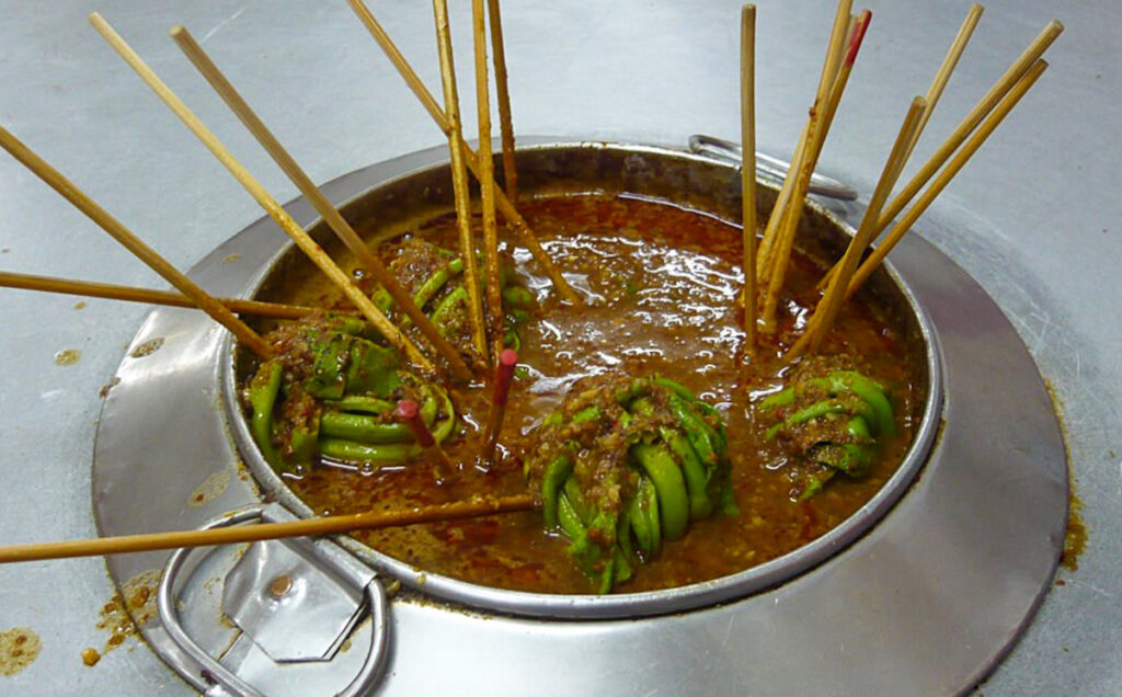 A pot of food with some sticks in it
