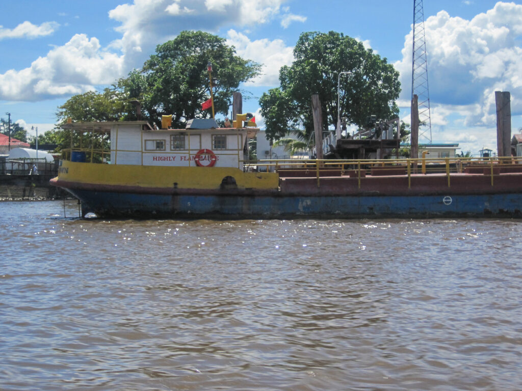 A large yellow boat floating on top of water.