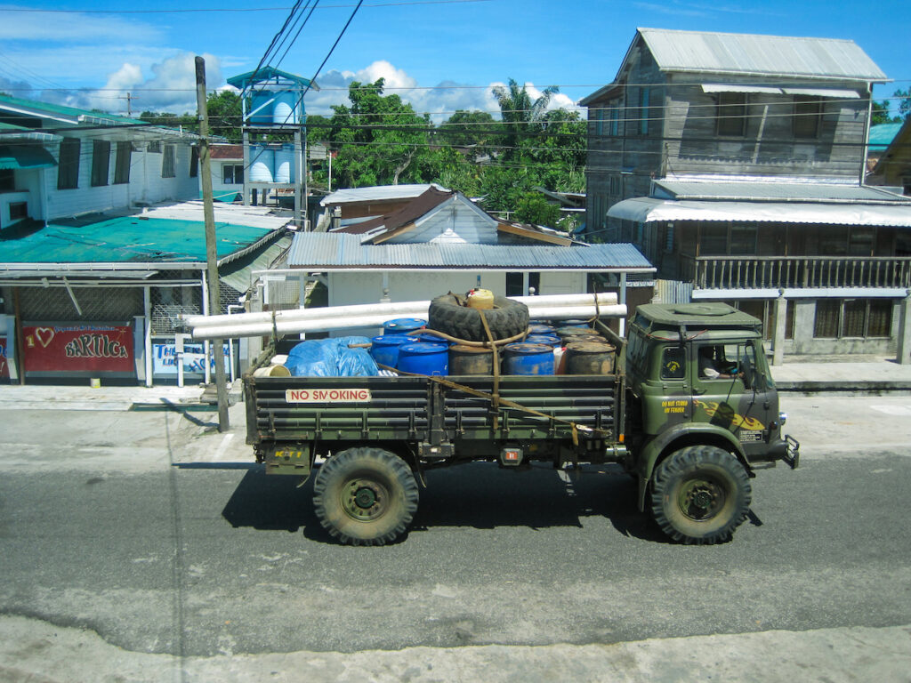 A truck with many bags on the back of it.