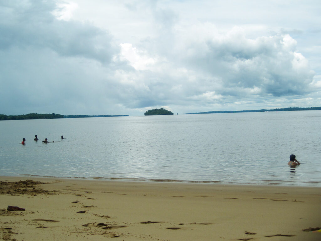 A body of water with people swimming in it.