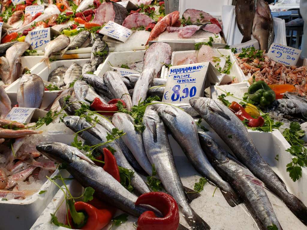 A table full of fresh fish and vegetables.