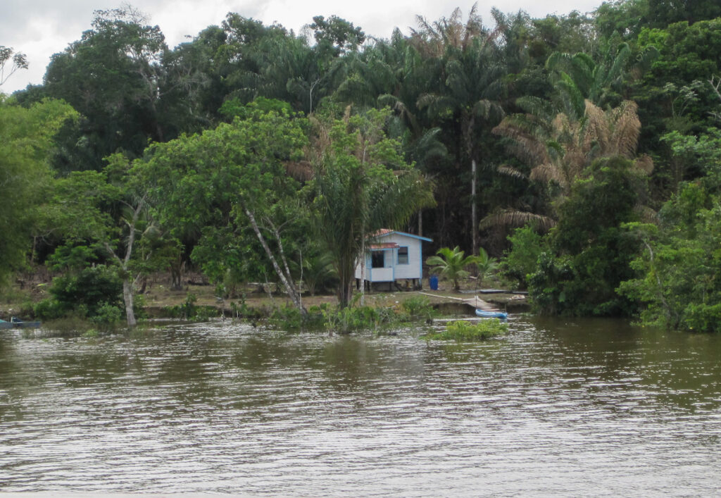 A house on the water near some trees