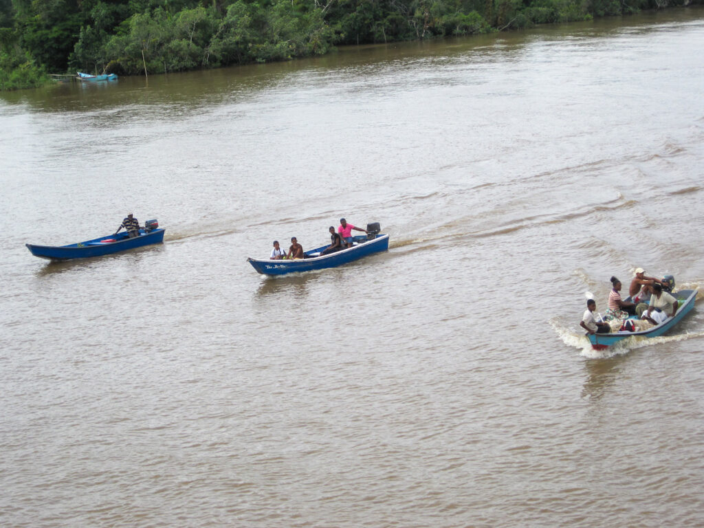 A group of people in boats on the water.
