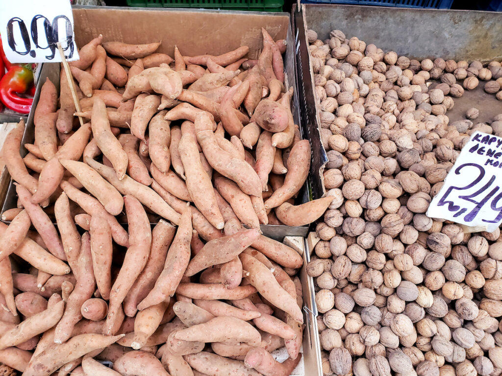 A box of sweet potatoes and nuts are on display.