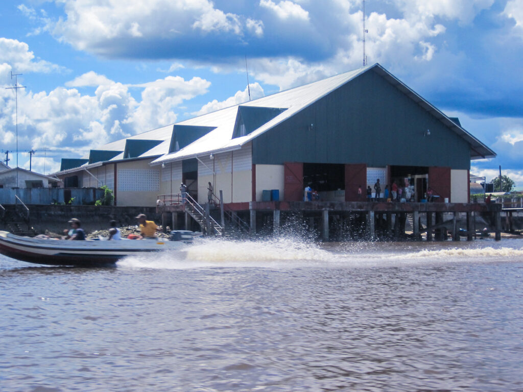 A boat is in the water near some buildings.