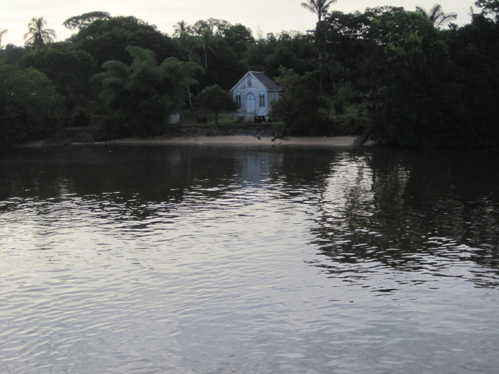 A house is seen from the water.