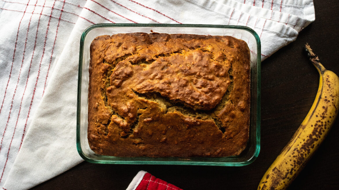 A loaf of banana bread in a glass pan.