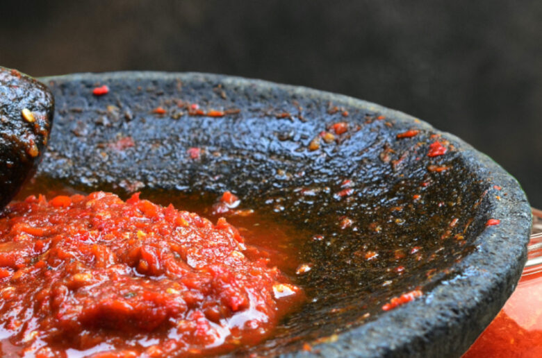 A bowl of sauce is being cooked in the pan.