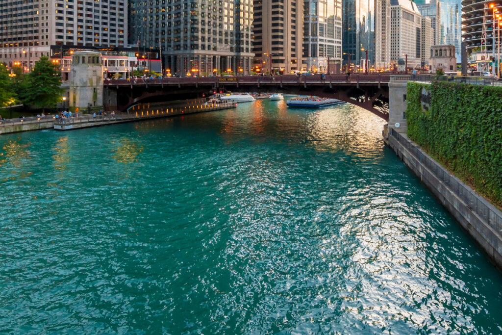 a green river going under a bridge