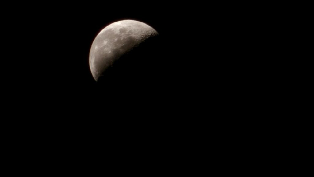 black sky with moon disappearing