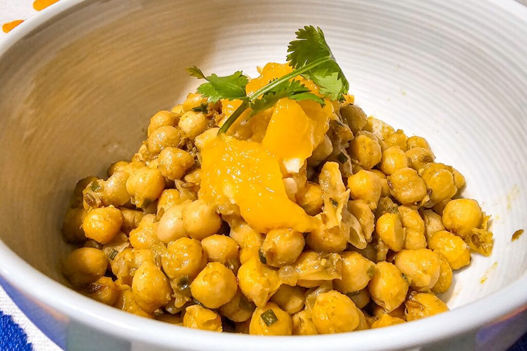 chickpeas in a bowl with mango sauce and cilantro