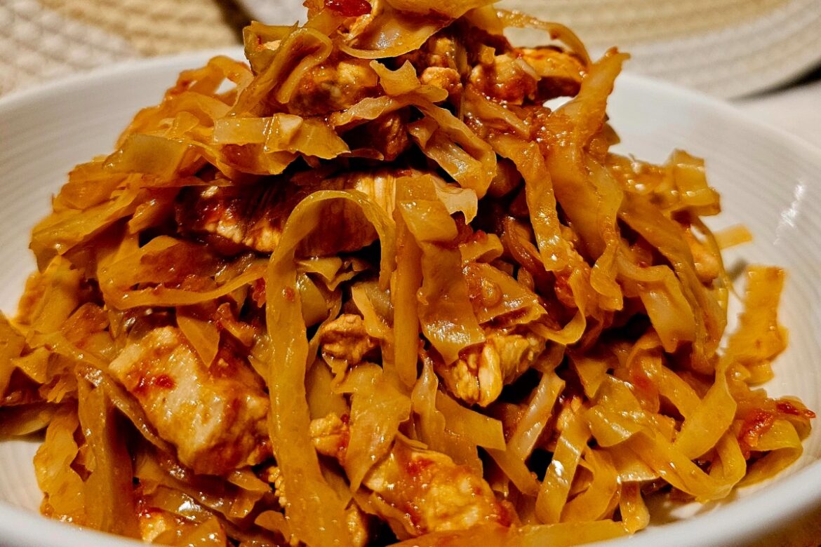 a dish with cooked cabbage and chicken